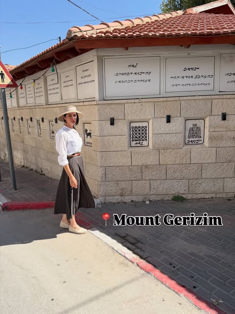 Standing in front of the Samaritan synagogue on Mount Gerizim, their holiest site on earth. The inscriptions on the wall are in the ancie…
